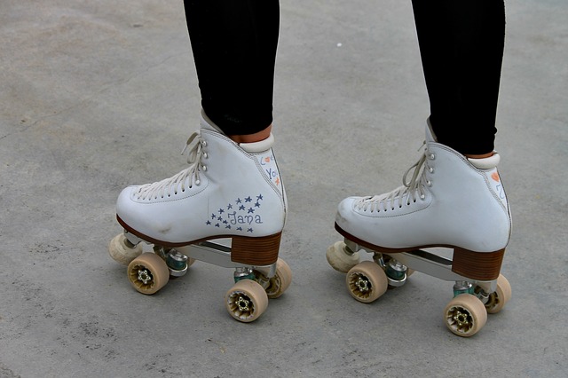 Ankle down shot of person wearing white roller skates 